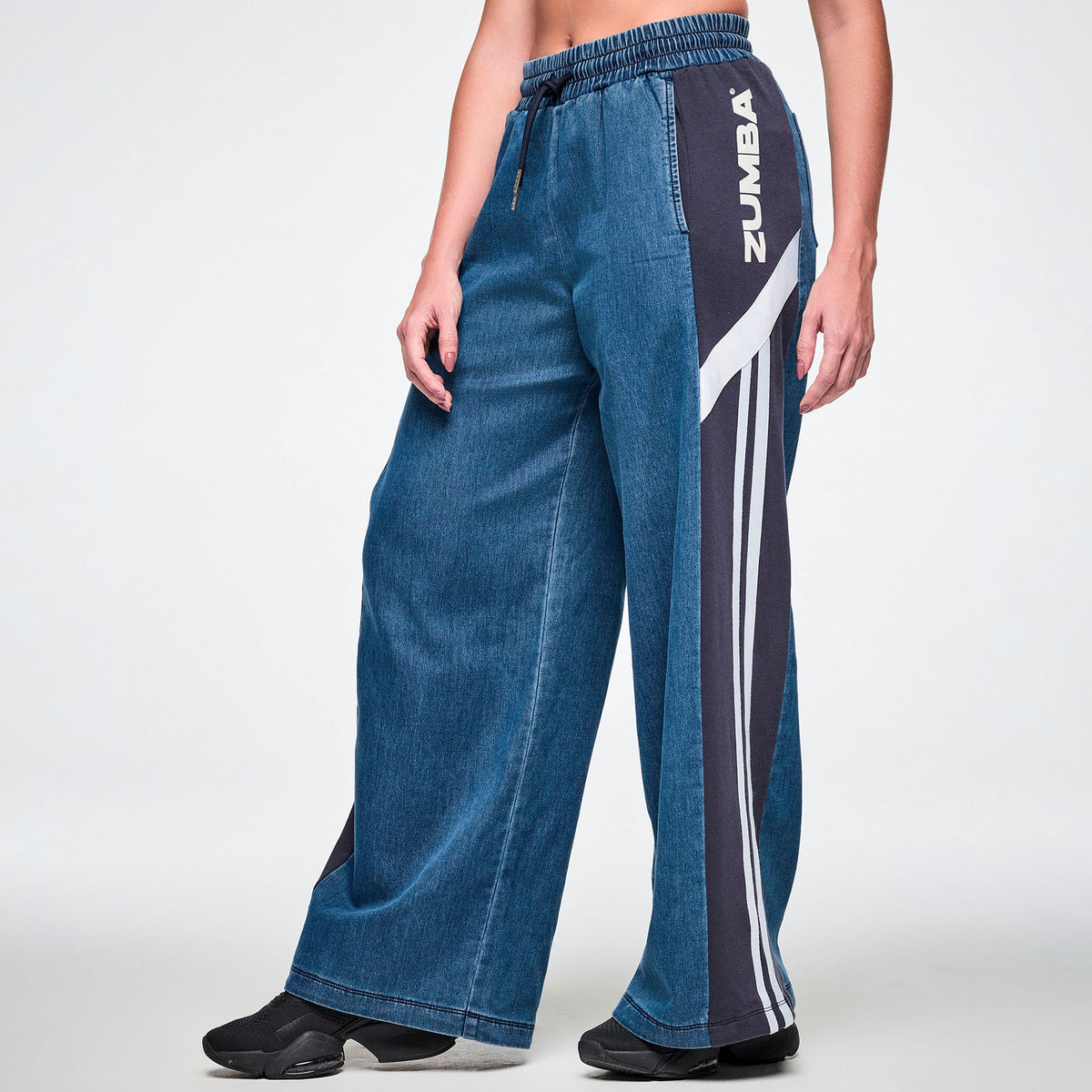 Jeansowe spodnie z szerokimi nogawkami i lampasami – widok z boku z logo ZUMBA | Zumba Wear
