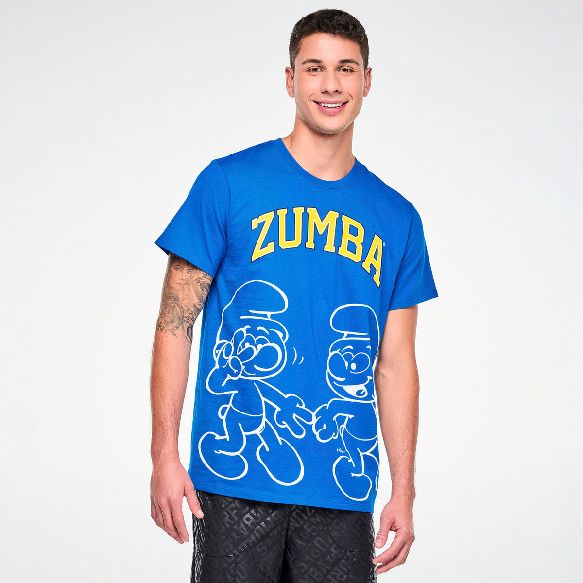 Niebieska koszulka unisex ze Smerfami – widok z przodu na modelu | Zumba Wear